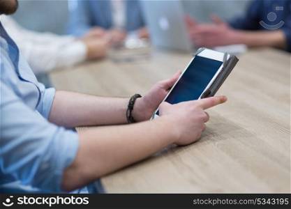 young casual businessman using tablet computer in startup office