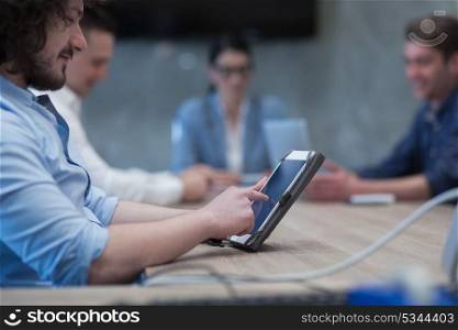 young casual businessman using tablet computer in startup office