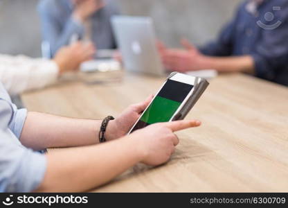 young casual businessman using tablet computer in startup office