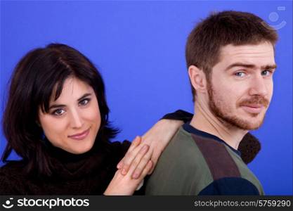 young casual couple together, isolated on blue background