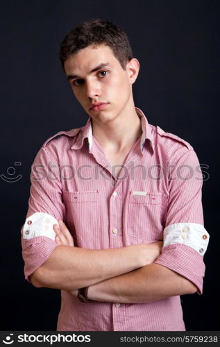 young casual man against a black background