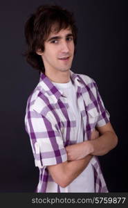 young casual man against a black background