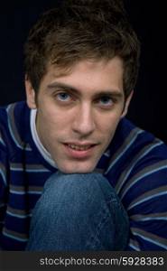 young casual man against a black background