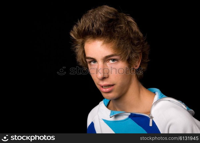 young casual man against a black background