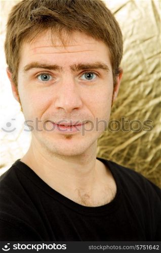 young casual man against a golden background