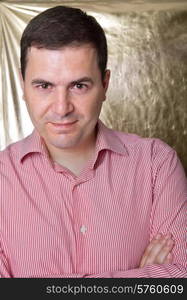 young casual man against a golden background