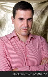 young casual man against a golden background