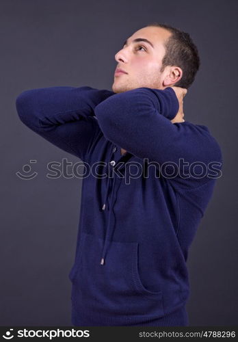 young casual man close up portrait on a dark background