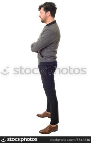 young casual man full body from the side in a white background. casual man