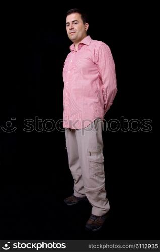 young casual man full body on a black background