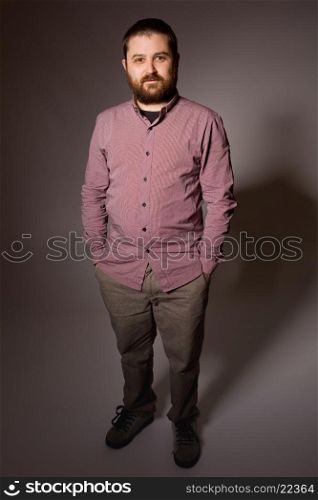 young casual man full length in a dark background