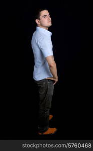 young casual man full length, on a black background