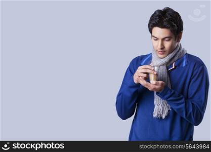 Young casual man holding chai