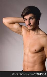 young casual man in topless, studio picture