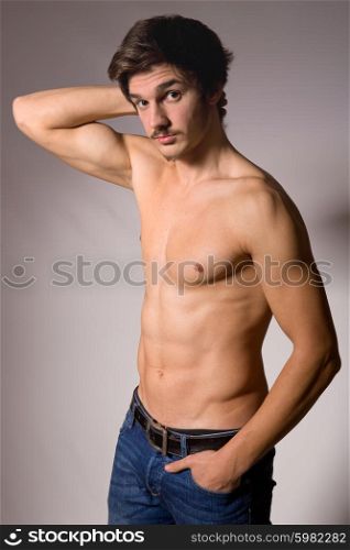 young casual man in topless, studio picture