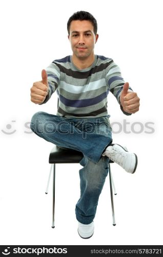 young casual man on a chair going thumbs up, isolated on white