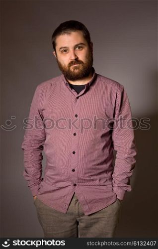 young casual man portrait in a dark background