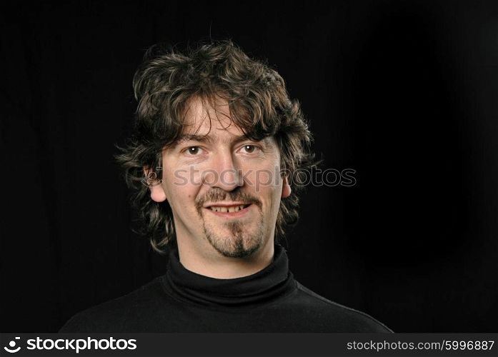 young casual man portrait in black background