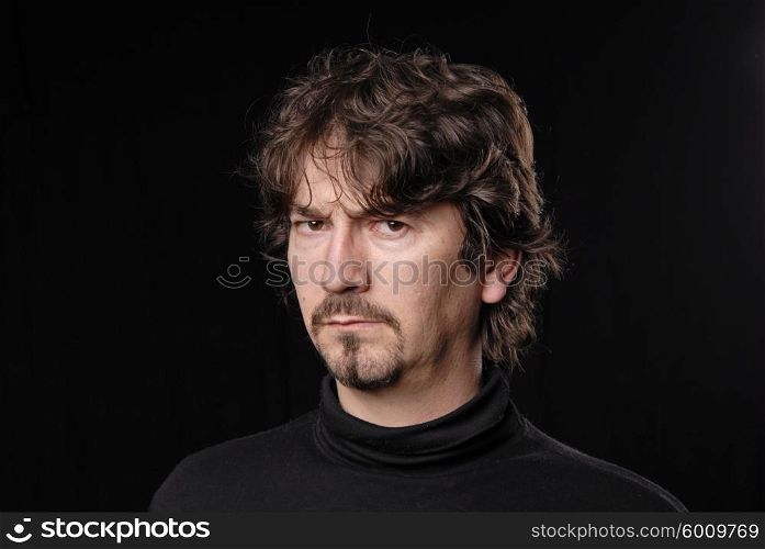 young casual man portrait in black background