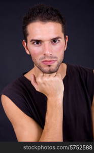 young casual man portrait on a black background