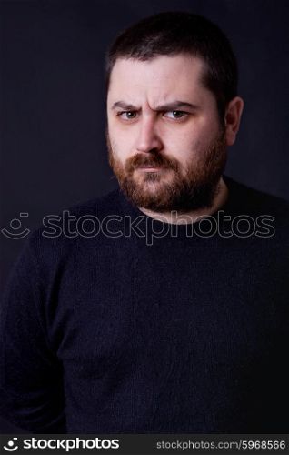 young casual man portrait on a black background