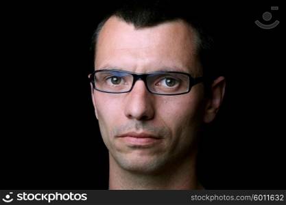 young casual man portrait on a black background