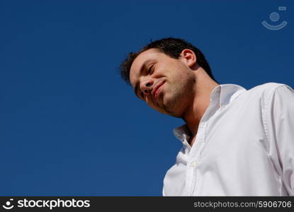 young casual man portrait with the sky as background