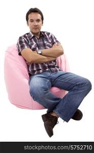 young casual man seated in a small sofa