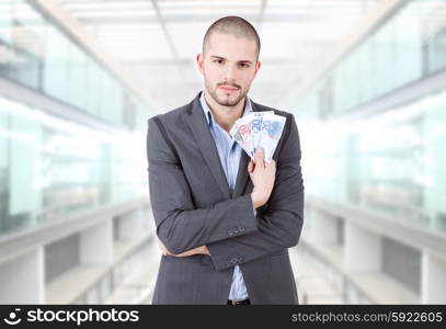 young casual man with lots of money at the office