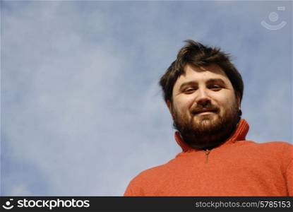 young casual man with the sky as background