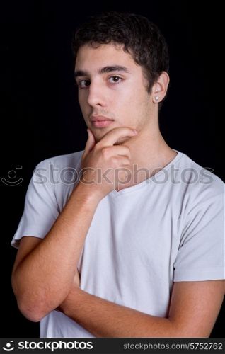 young casual pensive man on a black background