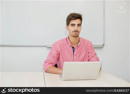 young casual teenager student in the classroom. student