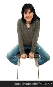 young casual woman on a chair, isolated on white