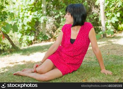 young casual woman posing seated, outdoors
