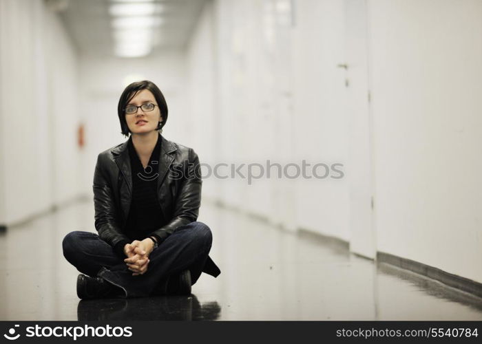 young casual woman sitting and precticing yoga indoor on abstract location