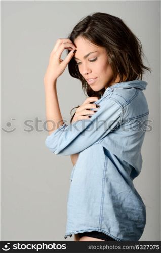 Young casual woman style over gray background. studio portrait female model. Beautiful smiling happy girl.