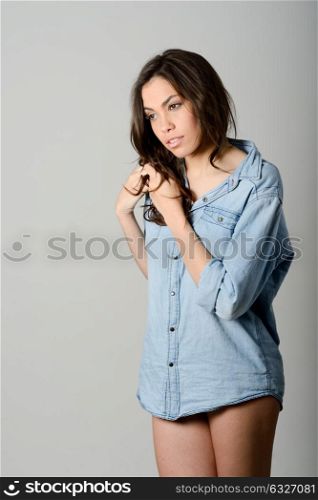 Young casual woman style over gray background. studio portrait female model. Beautiful smiling happy girl.