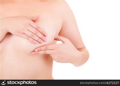 Young Caucasian adult woman examining her breast for lumps or signs of breast cancer