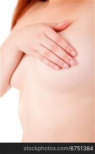 Young Caucasian adult woman examining her breast for lumps or signs of breast cancer