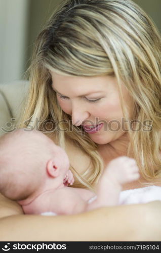 Young Caucasian Beautiful Mother Holding Her Precious Newborn Baby Girl.