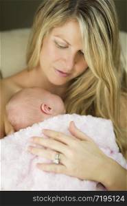 Young Caucasian Beautiful Mother Holding Her Precious Newborn Baby Girl.