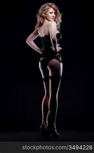 ""young caucasian blonde woman wearing sexy lingerie; over black, studio shot""