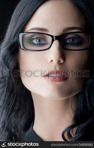 young caucasian brunette wearing glasses, close-up studio shot
