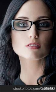 young caucasian brunette wearing glasses, close-up studio shot