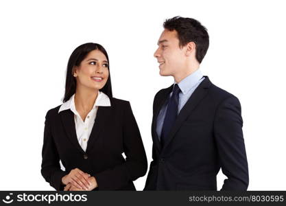 Young Caucasian business man is smiling at a business woman. A young Caucasian business man is looking and smiling at a business woman. They are standing together.