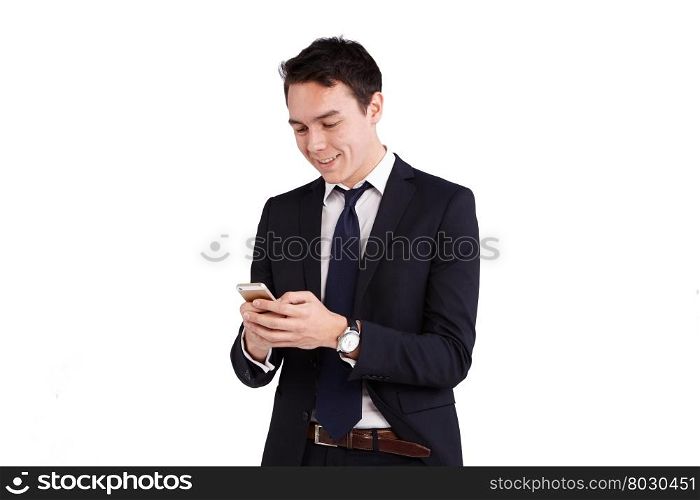 Young Caucasian business man looking at mobile phone. A young Caucasian smiling while looking at his mobile phone. His finger is operating on the smart phone screen.