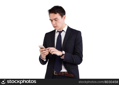 Young Caucasian business man looking at mobile phone. A young Caucasian frowning while looking at his mobile phone. His finger is operating on the screen.