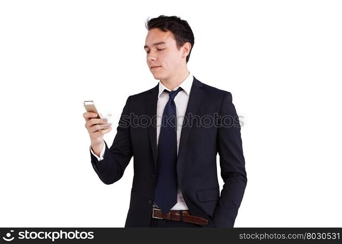 Young Caucasian business man looking at mobile phone. A young Caucasian business man is looking and holding his mobile phone. His finger is on the screen operating the smart phone. He is smiling.