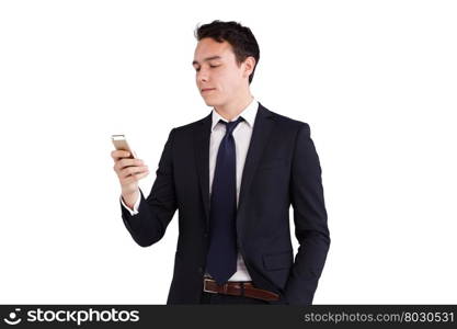 Young Caucasian business man looking at mobile phone. A young Caucasian business man is looking and holding his mobile phone. His finger is on the screen operating the smart phone. He is smiling.