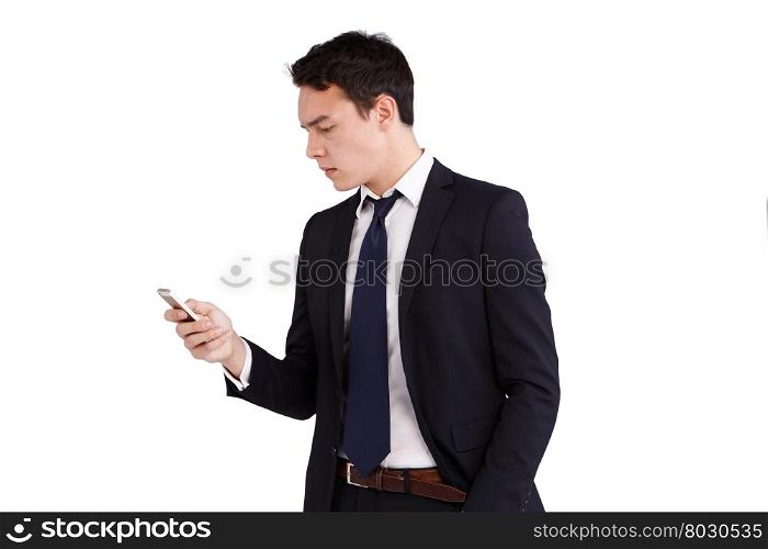 Young Caucasian business man looking at mobile phone. A young Caucasian business man is looking at his mobile phone. His finger is on the screen operating the smart phone.